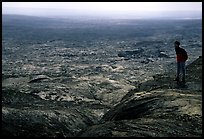 Hiker on top of Mauna Ulu crater. Hawaii Volcanoes National Park, Hawaii, USA. (color)