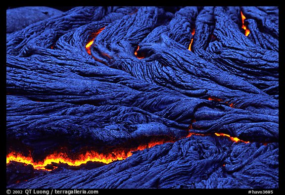 Close-up of ripples of flowing pahoehoe lava at dusk. Hawaii Volcanoes National Park, Hawaii, USA.