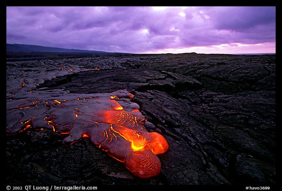 Flowing lava and rain clouds at dawn. Hawaii Volcanoes National Park, Hawaii, USA.