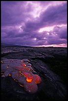 Live lava glows at dawn on coastal plain. Hawaii Volcanoes National Park, Hawaii, USA.