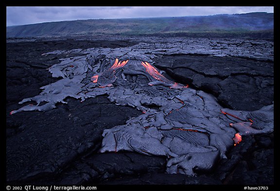 Live hot lava flows over hardened lava. Hawaii Volcanoes National Park (color)