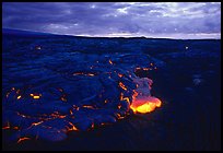 Red lava glows at dawn. Hawaii Volcanoes National Park, Hawaii, USA.