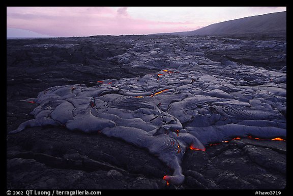 Live lava flow at sunset near the end of Chain of Craters road. Hawaii Volcanoes National Park, Hawaii, USA.
