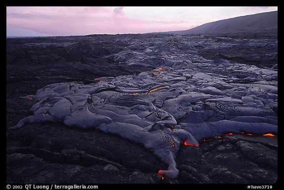 Live lava flow at sunset near the end of Chain of Craters road. Hawaii Volcanoes National Park, Hawaii, USA.