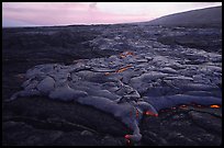 Live lava flow at sunset near the end of Chain of Craters road. Hawaii Volcanoes National Park, Hawaii, USA.