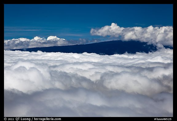 Mauna Loa emerging above clouds. Hawaii Volcanoes National Park, Hawaii, USA.