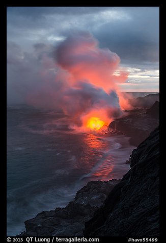 Coastline with steam illuminated by molten lava. Hawaii Volcanoes National Park, Hawaii, USA.