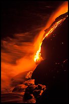 Lava flow entering Pacific Ocean at night. Hawaii Volcanoes National Park, Hawaii, USA. (color)