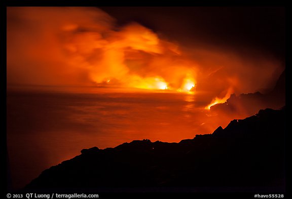 Hydrochloric steam clouds glow by lava light on coast. Hawaii Volcanoes National Park, Hawaii, USA.
