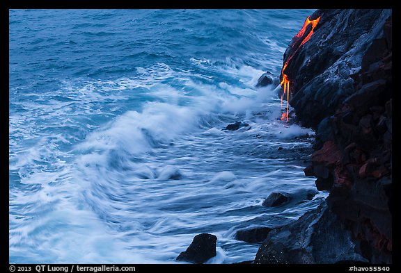 Waves and hot lava dripping from lava bench. Hawaii Volcanoes National Park, Hawaii, USA.