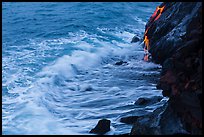Waves and hot lava dripping from lava bench. Hawaii Volcanoes National Park, Hawaii, USA. (color)
