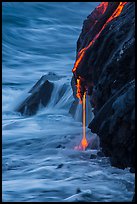 Hot lava drips into ocean waters at dawn. Hawaii Volcanoes National Park, Hawaii, USA. (color)