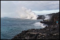 Hiker and volcanic steam cloud on coast. Hawaii Volcanoes National Park, Hawaii, USA. (color)