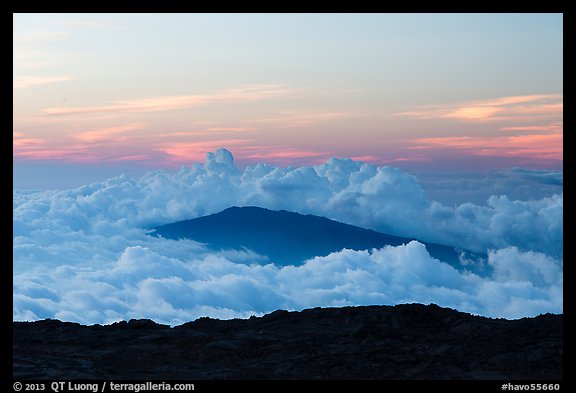 Puu Waawaa summit emerging from sea of clouds at sunset. Hawaii Volcanoes National Park, Hawaii, USA.