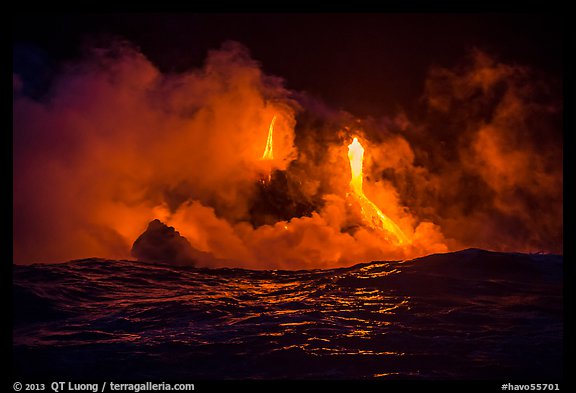 Lava cascades lighting ocean at night. Hawaii Volcanoes National Park, Hawaii, USA.