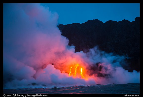 Lava flows cascade down sea cliff at dawn. Hawaii Volcanoes National Park, Hawaii, USA.