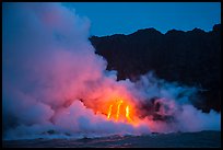 Lava flows cascade down sea cliff at dawn. Hawaii Volcanoes National Park, Hawaii, USA. (color)