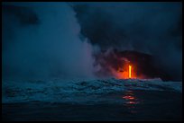 Lava runs down the cliff and goes into the sea at dawn. Hawaii Volcanoes National Park, Hawaii, USA.