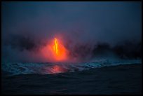 Lava flow at dawn, ocean reflection, and steam plume. Hawaii Volcanoes National Park, Hawaii, USA.