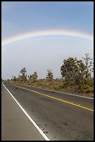 Rainbow above highway. Hawaii Volcanoes National Park, Hawaii, USA. (color)