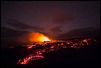 Molten lava flow and plume from ocean entry with stary sky at night. Hawaii Volcanoes National Park, Hawaii, USA. (color)