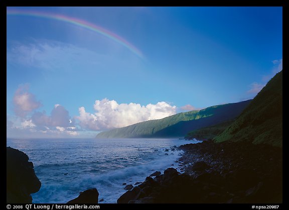 Rainbow and Mataalaosagamai sea cliffs in the distance, Tau Island. National Park of American Samoa