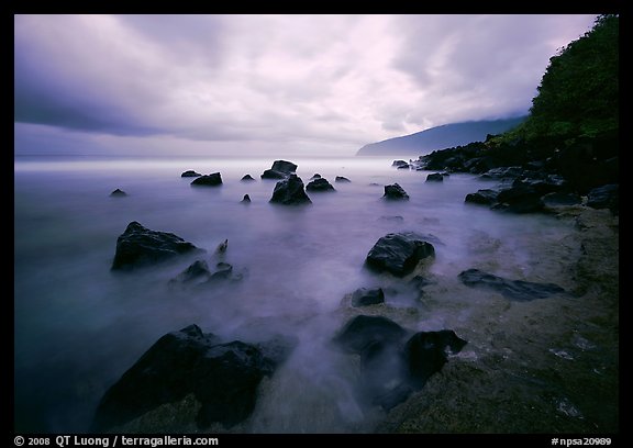 Seascape with smooth water, clouds and rocks, Siu Point, Tau Island. National Park of American Samoa