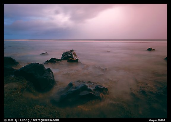 Rocks in water and approaching storm, Siu Point, Tau Island. National Park of American Samoa