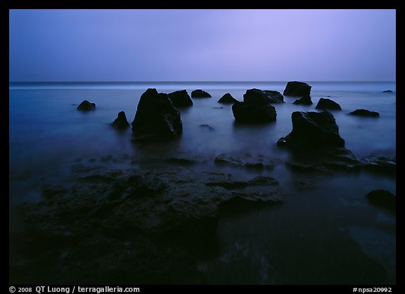 Rocks in water at dusk, Siu Point, Tau Island. National Park of American Samoa