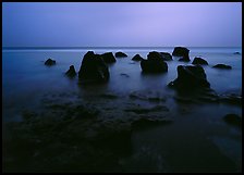 Rocks in water at dusk, Siu Point, Tau Island. National Park of American Samoa