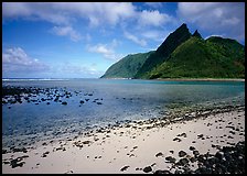 Tropical beach with sand and pebbles, and pointed peaks of Ofu Island. National Park of American Samoa (color)