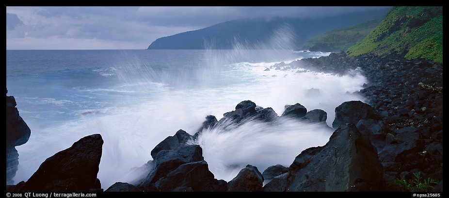 Shoreline with black rock pounded by strong surf, Tau Island. National Park of American Samoa