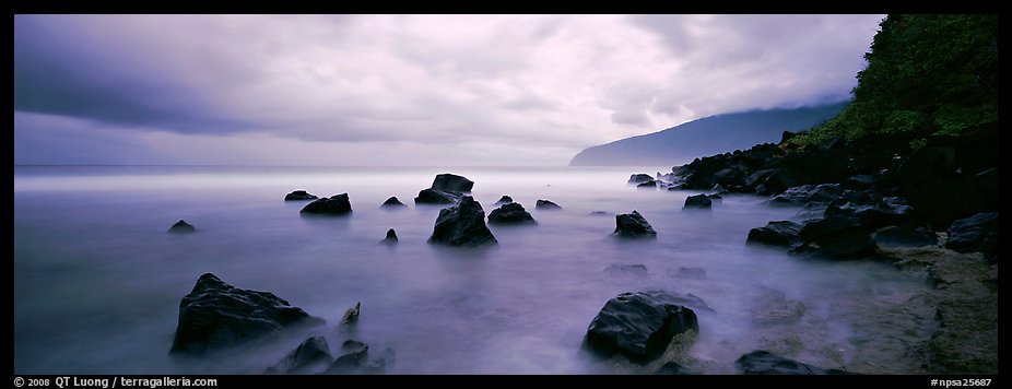 Coast with boulders and storm clouds, Tau Island. National Park of American Samoa