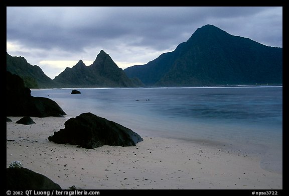 Balsalt boulders on South Beach, Sunuitao Peak and Piumafua mountain on Olosega Island in the background, Ofu Island. National Park of American Samoa