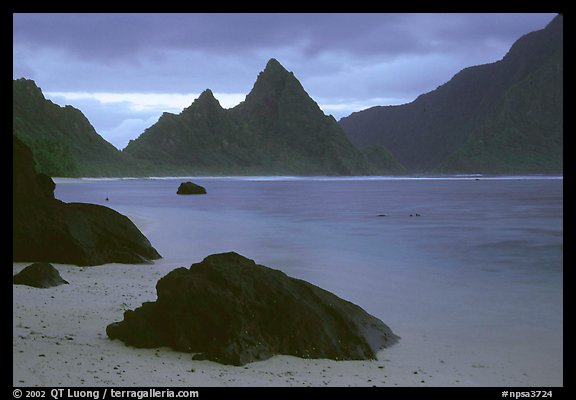 Balsalt boulders on South Beach, Sunuitao Peak in the background, Ofu Island. National Park of American Samoa