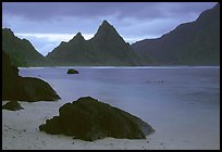 Balsalt boulders on South Beach, Sunuitao Peak in the background, Ofu Island. National Park of American Samoa