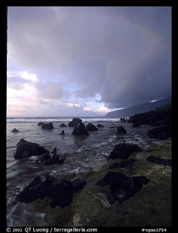 Boulders and coastline at sunrise with rainbow, Siu Point, Tau Island. National Park of American Samoa (color)