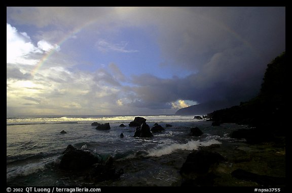 Boulders and coastline at sunrise with rainbow, Siu Point, Tau Island. National Park of American Samoa (color)