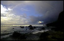 Boulders and coastline at sunrise with rainbow, Siu Point, Tau Island. National Park of American Samoa (color)