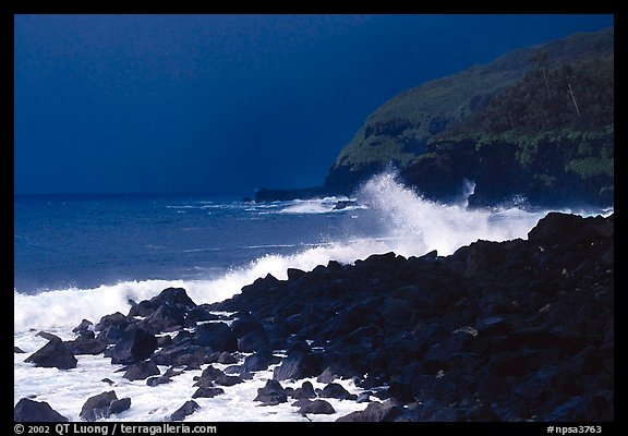 Dark boulders, crashing waves, and dark sky, storm light, Tau Island. National Park of American Samoa (color)