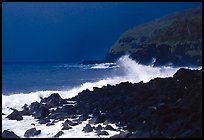 Dark boulders, crashing waves, and dark sky, storm light, Tau Island. National Park of American Samoa
