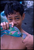 Samoan boy with freshly catched tropical fish, Tau Island. National Park of American Samoa