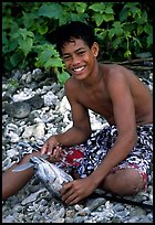 Samoan boy with fish, Tau Island. National Park of American Samoa (color)