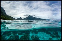 Over-under split view of Ofu South Beach Lagoon and jagged mountains. National Park of American Samoa ( color)