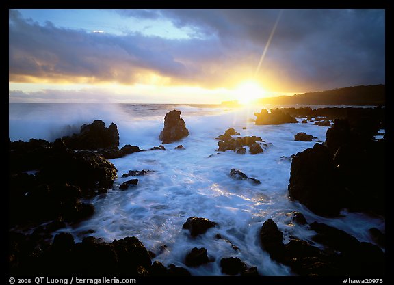Sun and surf over rugged rocks, Kenae Peninsula. Maui, Hawaii, USA
