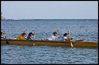 Young women padding a hawaiian outrigger canoe, Maunalua Bay, late afternoon. Oahu island, Hawaii, USA (color)