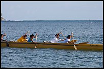 Young women padding a hawaiian outrigger canoe, Maunalua Bay, late afternoon. Oahu island, Hawaii, USA (color)