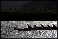 Backlit outrigger canoe, Maunalua Bay, late afternoon. Oahu island, Hawaii, USA