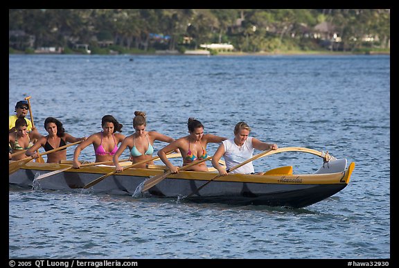 Outrigger canoe paddled by women in bikini, Maunalua Bay, late afternoon. Oahu island, Hawaii, USA (color)