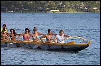 Outrigger canoe paddled by women in bikini, Maunalua Bay, late afternoon. Oahu island, Hawaii, USA ( color)
